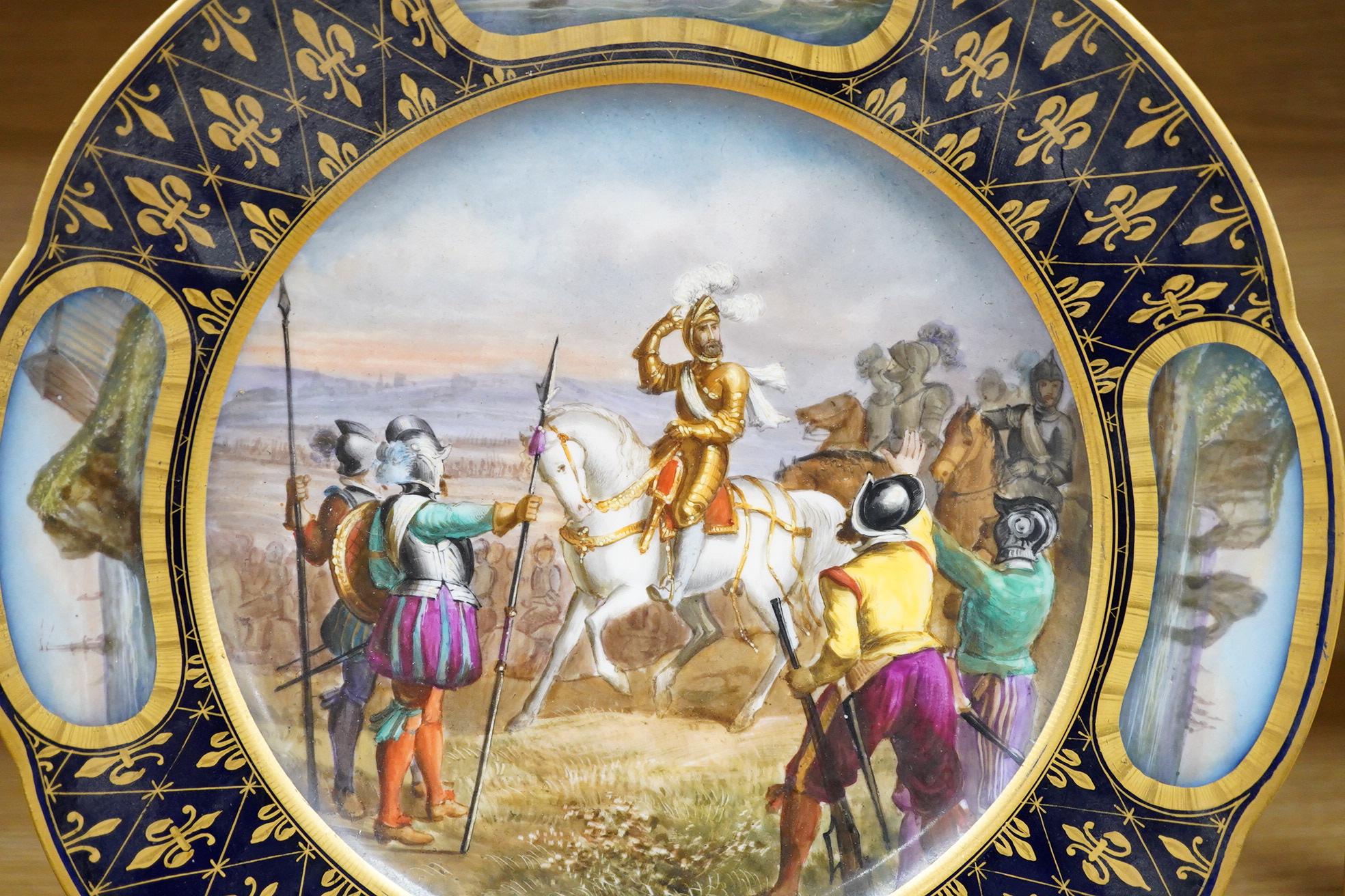 A Sevres style cabinet plate, with a central cartouche of Henri IV at the battle of Ivry 25.5cm diameter.
